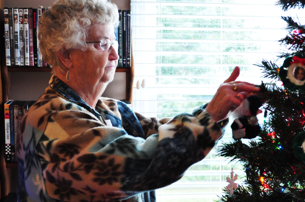 Judy Thompson puts an ornament on her tree, one of her only contributions to decorating her house for the holidays.  Mary and her two daughters, Danielle and Taylor, do most of the decorating.